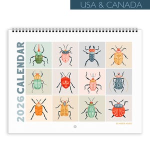 May include: 2026 calendar featuring colorful illustrations of various beetles. The calendar has a spiral binding and includes the text "2026 CALENDAR" on the left side. The top of the calendar reads "USA & CANADA".