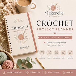 May include: A spiral-bound crochet project planner with a cream cover featuring a yarn ball and hook illustration, the text "CROCHET PROJECT PLANNER" and "Makerelle STUDIO", accompanied by a gold crochet hook, yarn balls, and a coffee mug.