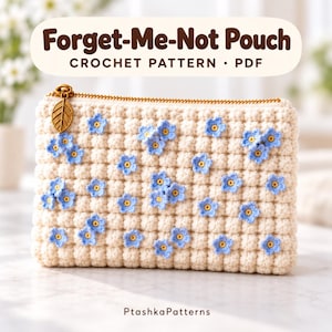 May include: A cream-colored crochet pouch featuring a textured bobble stitch pattern and small blue forget-me-not flower appliqués. The pouch has a gold-tone zipper with a leaf-shaped charm. Text reads: Forget-Me-Not Pouch CROCHET PATTERN • PDF PtashkaPatterns.