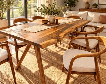 May include: A rectangular wooden dining table with a natural live edge, supported by angled legs. The table is surrounded by four wooden chairs featuring curved backrests and light beige upholstered seats, arranged on a textured jute rug.