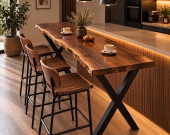 May include: A live edge wooden bar table with a dark brown grain and a black metal X-shaped base, accompanied by three matching wooden bar stools with black metal frames. Two white ceramic cups on saucers and a small bowl sit on the table.