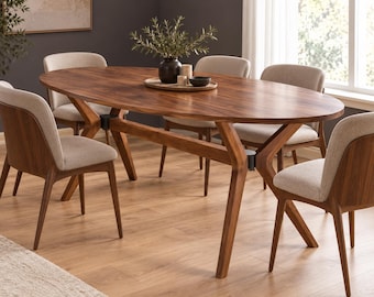 May include: An oval wooden dining table with a dark brown finish and angled legs, accompanied by six chairs featuring light beige upholstered seats and backrests, with a dark vase and a wooden tray placed on the center of the tabletop.