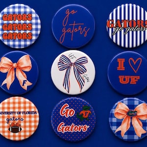 May include: Nine circular pin-back buttons featuring University of Florida Gators themes. Designs include blue and white gingham, stripes, polka dots, orange bows, a football, and text reading GATORS, go gators, I heart UF, and University of Florida.