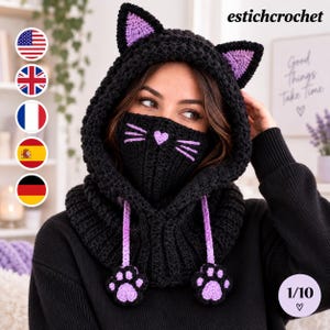 May include: A black crochet hooded cowl featuring cat ears with purple centres, a matching face mask with a purple heart nose and whiskers, and two dangling purple and black paw-shaped tassels. The text estichcrochet is visible in the top right corner.
