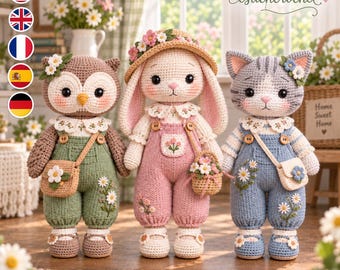 May include: Three crocheted stuffed animals: an owl in green overalls, a rabbit in pink overalls with a floral hat, and a cat in blue overalls. Each figure wears a white lace collar, carries a small bag, and features embroidered daisy details.