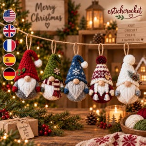 May include: Five crocheted gnome ornaments hanging from a string. The gnomes feature various hats in red, green, blue, and white, decorated with pom-poms, snowflakes, and holly. Each gnome has a round nose, a white beard, and a textured body.