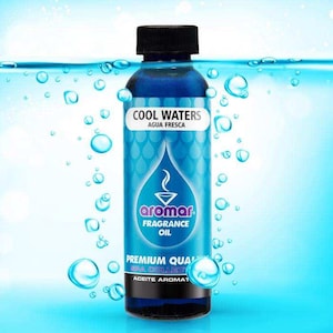 May include: A clear plastic bottle filled with blue fragrance oil, topped with a black screw cap. The label features the text COOL WATERS AGUA FRESCA, the Aromar logo, FRAGRANCE OIL, PREMIUM QUALITY SPA COLLECTION, and ACEITE AROMATICO.
