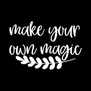May include: A black graphic design featuring the white text "make your own magic" in a cursive script font. Below the text is a horizontal decorative element consisting of a stylized branch with rounded leaves extending to the right side.