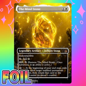 May include: A rectangular trading card titled The Mind Stone featuring a glowing yellow crystal centerpiece surrounded by smaller floating crystals against a golden background. The card text includes Legendary Artifact, Infinity Stone, and game rules.