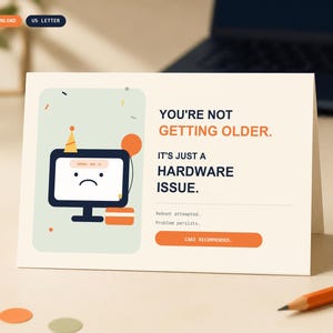 May include: A folded greeting card with a cream background featuring a graphic of a computer monitor wearing a party hat with a sad face. The text reads: YOU'RE NOT GETTING OLDER. IT'S JUST A HARDWARE ISSUE. Reboot attempted. Problem persists. CAKE RECOMMENDED.