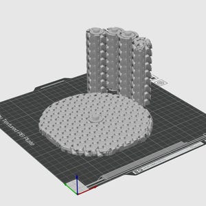 Op de afbeelding: Een 3D-modelweergave van een cirkelvormige plaat met honingraatpatroon en een verticaal, cilindrisch onderdeel met een tandwielachtige textuur, beide weergegeven op een vierkant Bambu Textured PEI Plate-oppervlak met zichtbare rasterlijnen.
