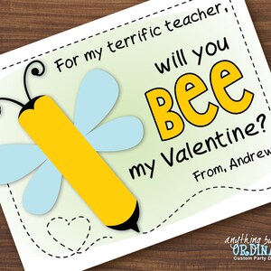 May include: A Valentine's Day card featuring a cartoon bee with the text "For my terrific teacher, will you bee my Valentine? From, Andrew".