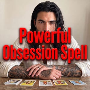 May include: A person with long dark hair and arm tattoos wearing a white shirt sits behind a wooden table with tarot cards laid out. The text "Powerful Obsession Spell" is displayed in large red letters across the center of the image.