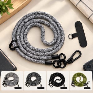May include: A coiled gray and white speckled rope lanyard featuring black metal hardware, including a lobster clasp, circular rings, and a flat black rectangular phone tether tab. The set includes four color variations: gray, dark gray, black, and olive green.