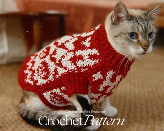 May include: A white and gray cat wearing a red and white crocheted Christmas sweater. The sweater has a snowflake pattern. The text "Christmas Pet Sweater Crochet Pattern" is at the bottom of the image.