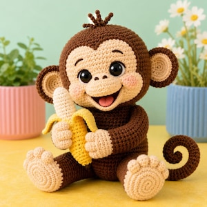 May include: A crocheted monkey soft toy with dark brown fur, a light beige face, and large black eyes. The monkey has pink cheeks, a wide smiling mouth with a visible tongue, and is holding a yellow crocheted banana in its hands.