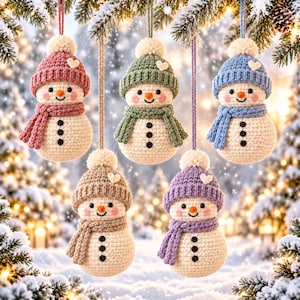 May include: Five crocheted snowman ornaments hanging from strings. Each snowman features a cream-colored body with three black buttons, a matching knit hat with a white pom-pom and a small white heart, and a scarf in pink, green, blue, tan, or purple.