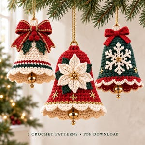 Three crochet Christmas bell ornaments with bow, poinsettia and snowflake designs hanging beside a warmly lit Christmas tree.