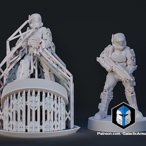 May include: Two unpainted 3D printed resin miniature figures of armoured soldiers holding rifles. One figure is attached to a complex support structure, while the other stands on a circular base with a logo reading Patreon.com/GalacticArmory.