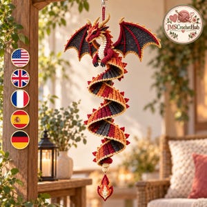 May include: A hanging crochet dragon ornament featuring a long, spiraling body in shades of red, orange, and dark gray. The dragon has detailed wings, small horns, and a cream-colored underbelly, ending in a pointed, flame-like decorative tassel.