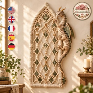 May include: A cream-colored crocheted wall hanging featuring a tall, arched gothic window frame design with green and yellow accents. A detailed, textured crocheted dragon is attached to the right side of the frame, with its tail extending downward.