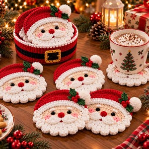 May include: A set of round, crocheted Santa Claus coasters featuring a red hat with a white pom-pom and holly berries, a beige face, and a white beard. The set includes a matching red and black crocheted storage basket with a yellow belt buckle.