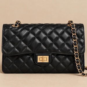 May include: A black quilted shoulder bag featuring a rectangular silhouette with a diamond-stitched pattern. The bag includes a gold-tone metal turn-lock closure on the front flap and a matching gold-tone chain strap interwoven with black material.