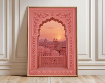 May include: A rectangular framed wall art print featuring a coral-pink arched window frame with intricate floral carvings. Through the arch, a sunset view of a city with domed buildings and a balcony railing is visible in soft, warm, monochromatic tones.