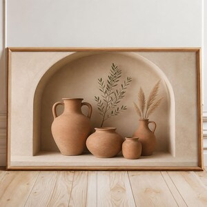 May include: A rectangular framed wall art piece featuring a beige arched alcove containing four terracotta-coloured clay vases of varying shapes and sizes. A sprig of green leaves and a cluster of dried pampas grass are arranged inside the vases.