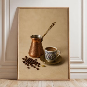 May include: A framed print featuring a copper coffee pot with an ornate handle, a ceramic cup filled with dark coffee on a matching saucer, and a small pile of roasted coffee beans with a single green cardamom pod on a light tan background.