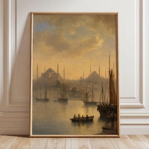 May include: A framed vertical wall art print depicting a harbour scene at sunset. The painting features a city skyline with mosque domes and minarets in the distance, several sailing ships on the water, and a small rowboat with four figures.