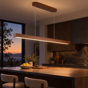 May include: A linear pendant light fixture featuring a long, rectangular wooden beam housing an integrated LED light strip. The fixture is suspended from the ceiling by two thin metal cables attached to a matching rectangular wooden canopy.