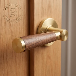 May include: A door handle featuring a cylindrical dark brown wood grip accented with brushed brass metal caps and a circular brass mounting plate, installed on a light oak wood door with a Brasselle Home Door Hardware logo stamp.