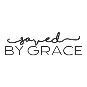 May include: A black embroidered design featuring the word saved in a cursive script font positioned above the words BY GRACE written in a clean, uppercase sans-serif typeface. The entire text is rendered in a bold, dark black thread.