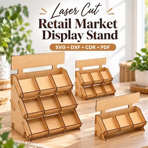 May include: Three light-coloured wooden retail display stands with tiered shelves. The text "Laser Cut Retail Market Display Stand" and "SVG • DXF • CDR • PDF" is printed above the stands. Each stand features a flat back panel and multiple open compartments for organising small items.