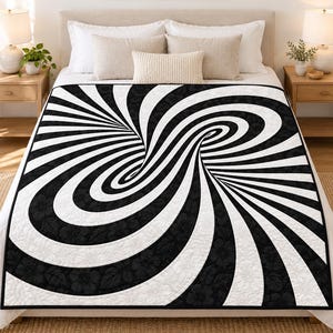 May include: A rectangular quilt featuring a black and white optical illusion pattern of swirling, curved lines that create a tunnel effect. The black sections of the design are decorated with a subtle, tonal floral print throughout the fabric.