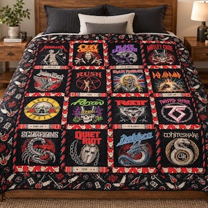 May include: A black quilt featuring a grid of sixteen colorful graphic panels showcasing various heavy metal and rock band logos and imagery, including Metallica, Ozzy Osbourne, Black Sabbath, Motley Crue, Judas Priest, Rush, Iron Maiden, Def Leppard, Guns N' Roses, Poison, Ratt, Twisted Sister, Scorpions, Quiet Riot, Dokken, and Whitesnake.