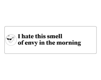 May include: A rectangular white sticker featuring a circular black and white line drawing of a person wearing a baseball cap and sunglasses on the left, with the black text "I hate this smell of envy in the morning" to the right.