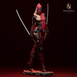 May include: A detailed figurine of a character in a red and black tactical suit with a blonde ponytail, wearing a mask with white eye patches. The figure holds two long silver swords, features a utility belt with a small charm, and stands on a base.