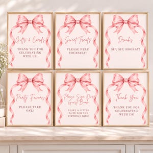 May include: Six rectangular signs with light pink backgrounds, each featuring a watercolor illustration of a pink ribbon bow at the top. The signs contain text including Gifts & Cards, Sweet Treats, Drinks, Party Favors, Guest Book, and Thank You.