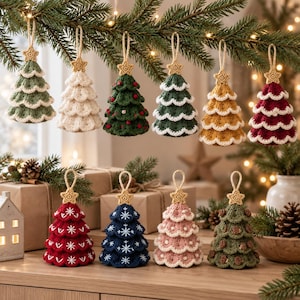 Könnte beinhalten: Eine Sammlung von zehn gehäkelten Weihnachtsbaumschmuckstücken in verschiedenen Farben wie Grün, Weiß, Rot, Blau, Rosa und Gold. Jeder Baum hat ein gestuftes Design mit einem kleinen gehäkelten Stern an der Spitze und einer Aufhängeschlaufe.