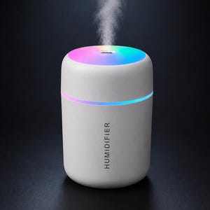 May include: A cylindrical white humidifier with the word HUMIDIFIER printed vertically in black. The top surface features a glowing multi-colored LED light, and a thin horizontal light band circles the middle. A fine mist rises from the center.
