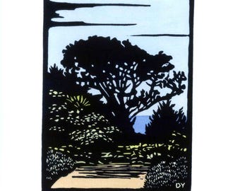 May include: A block print art piece titled Point Reyes, featuring a black silhouette of a large tree and coastal foliage against a pale blue sky. The print includes the text #25, Point Reyes, and the artist's signature DY in the bottom margin.