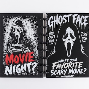 May include: A black disc-bound notebook featuring a white graphic of the Ghost Face character holding a cassette tape with the red text MOVIE NIGHT? on the left and the white text GHOST FACE YOU CAN'T HIDE I SEE YOU WHAT'S YOUR FAVORITE SCARY MOVIE? on the right.