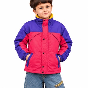 May include: A colour-blocked puffer jacket featuring a bright pink torso, purple sleeves and upper chest panel, and a mustard yellow inner collar. The jacket has a front placket with black snap buttons and two side pockets with purple trim.