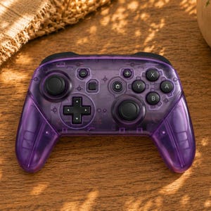 May include: A translucent purple wireless video game controller featuring black analog sticks, a black directional pad, and black action buttons labeled A, B, X, and Y. The controller includes a central home button, plus and minus buttons.