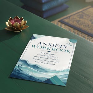 May include: An anxiety workbook with a white cover featuring blue watercolor waves, geometric shapes, and text that reads Anxiety Workbook for Recovery, Grounding Exercises, Panic Management Toolkit, Mindfulness Worksheets, and Healing Workbook.