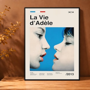 May include: A rectangular movie poster for La Vie d'Adèle featuring a black and white close-up of two faces facing each other against a bright blue background. The poster includes the title, the CNC logo, cast names, director, and the year 2013.