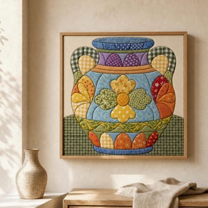 May include: A square framed textile wall art piece featuring a quilted applique design of a decorative vase. The vase is composed of various fabric patches in blue, yellow, green, orange, and purple, showcasing floral and checkered patterns.