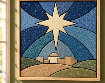 May include: A square fabric wall art piece in a light wood frame, featuring a central cream-colored star above a stylized town silhouette. The background consists of layered blue fabric segments with floral patterns and gold star accents.